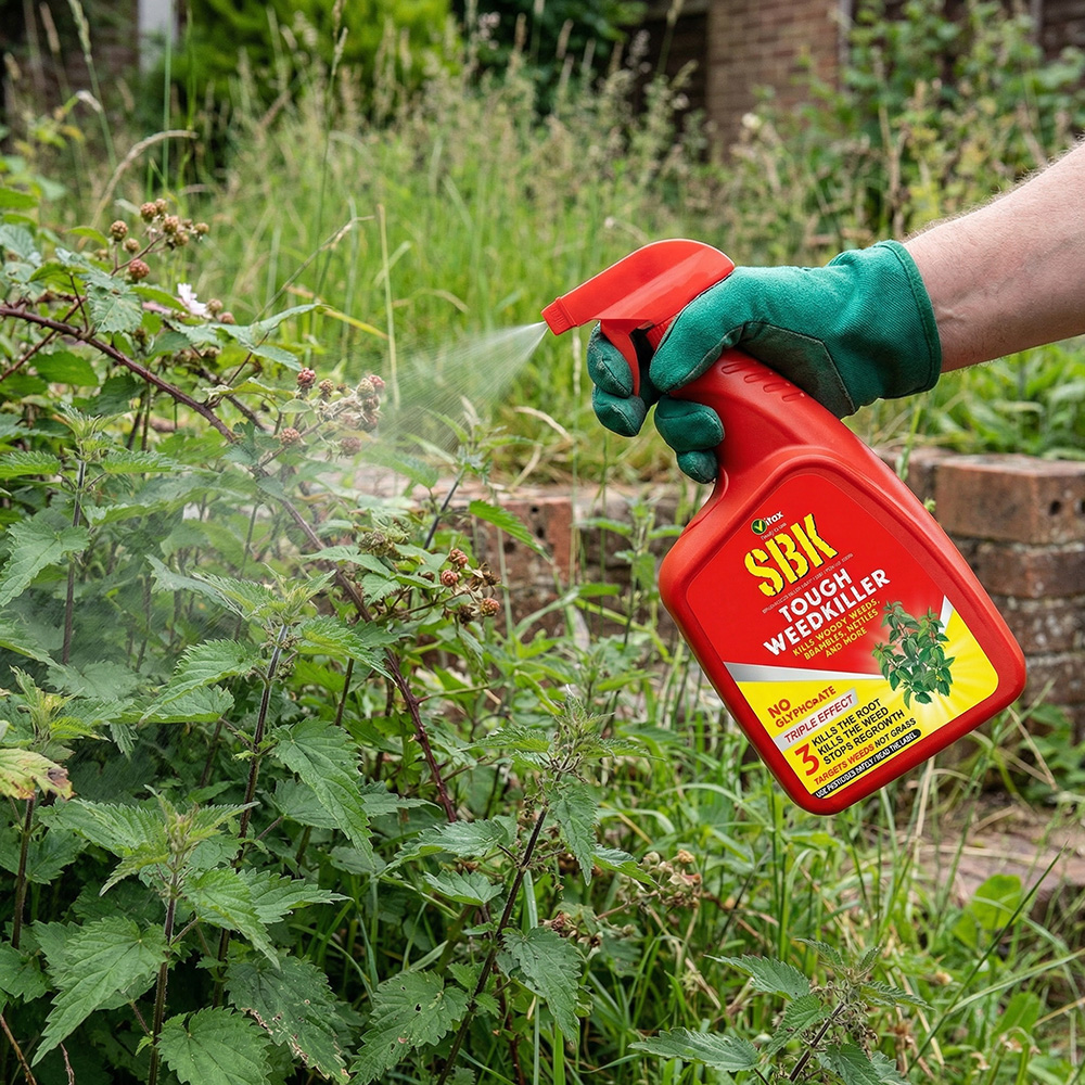 Sponsored banner gardener spraying SBK weed killer onto nettles