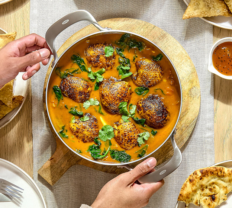 Person using the mira pan for cooking 