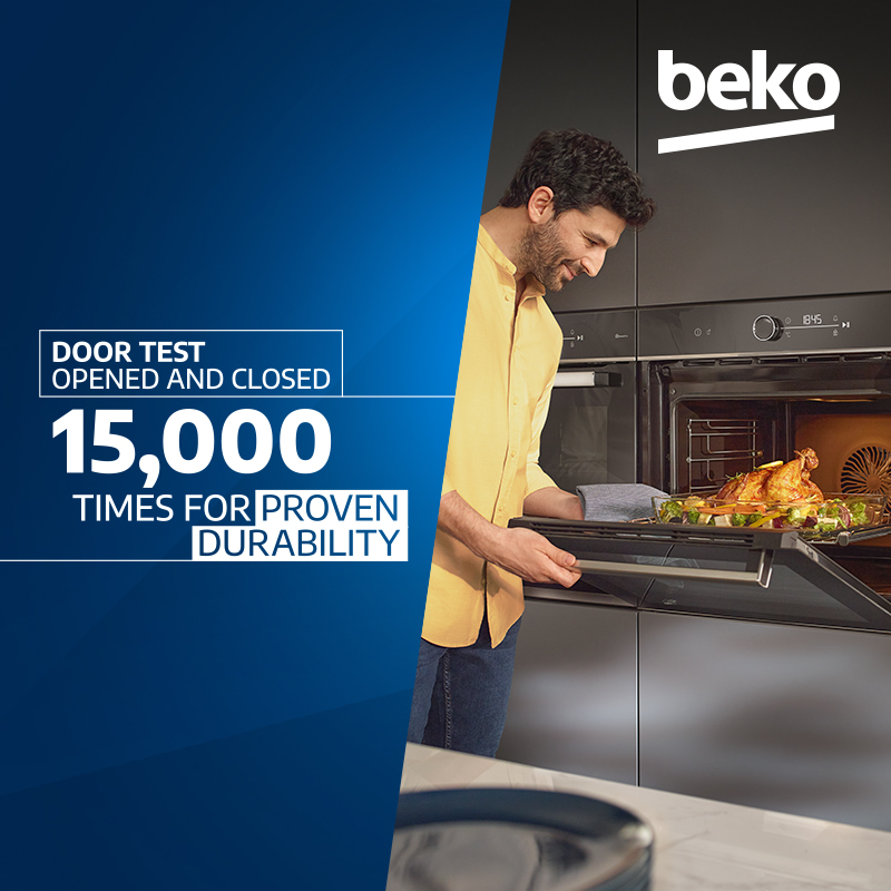 Sponsored Beko oven advertisement showing a man placing a tray of food into the oven, with text stating “Door test opened and closed 15,000 times for proven durability.
