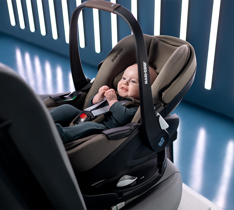 Picture of mother sliding baby out of the car