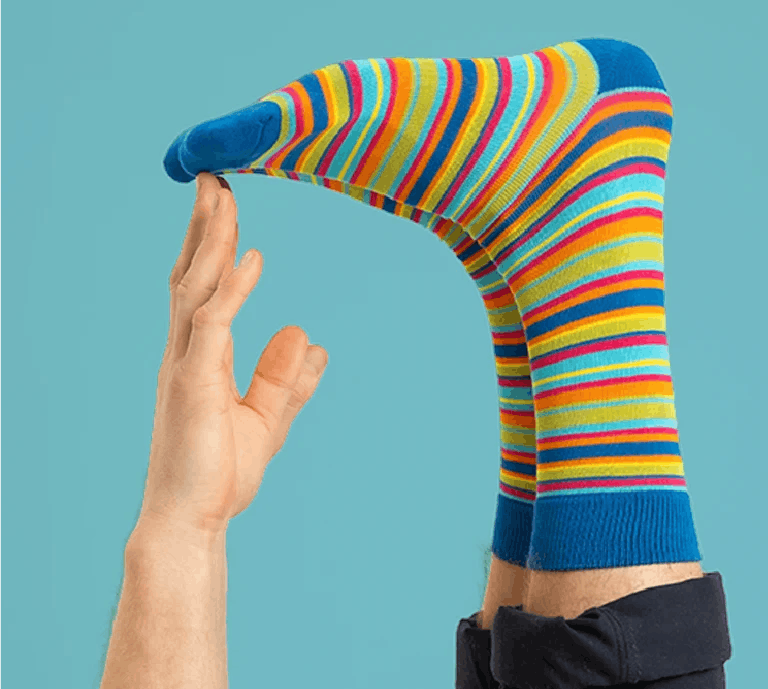 Close-up of feet in bold Oddballs socks with colorful stripe patterns