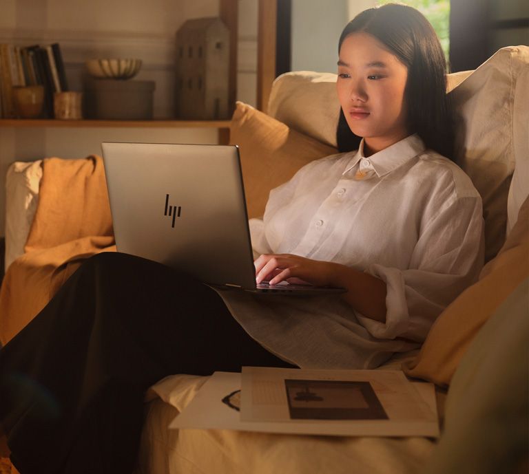 image contains woman using an HP laptop
