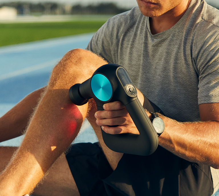 Image of man with Theragun