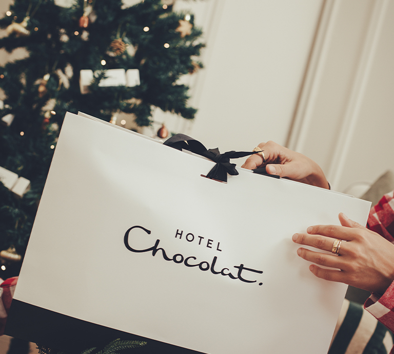 Christmas themed image with a Hotel Chocolat gift bag.