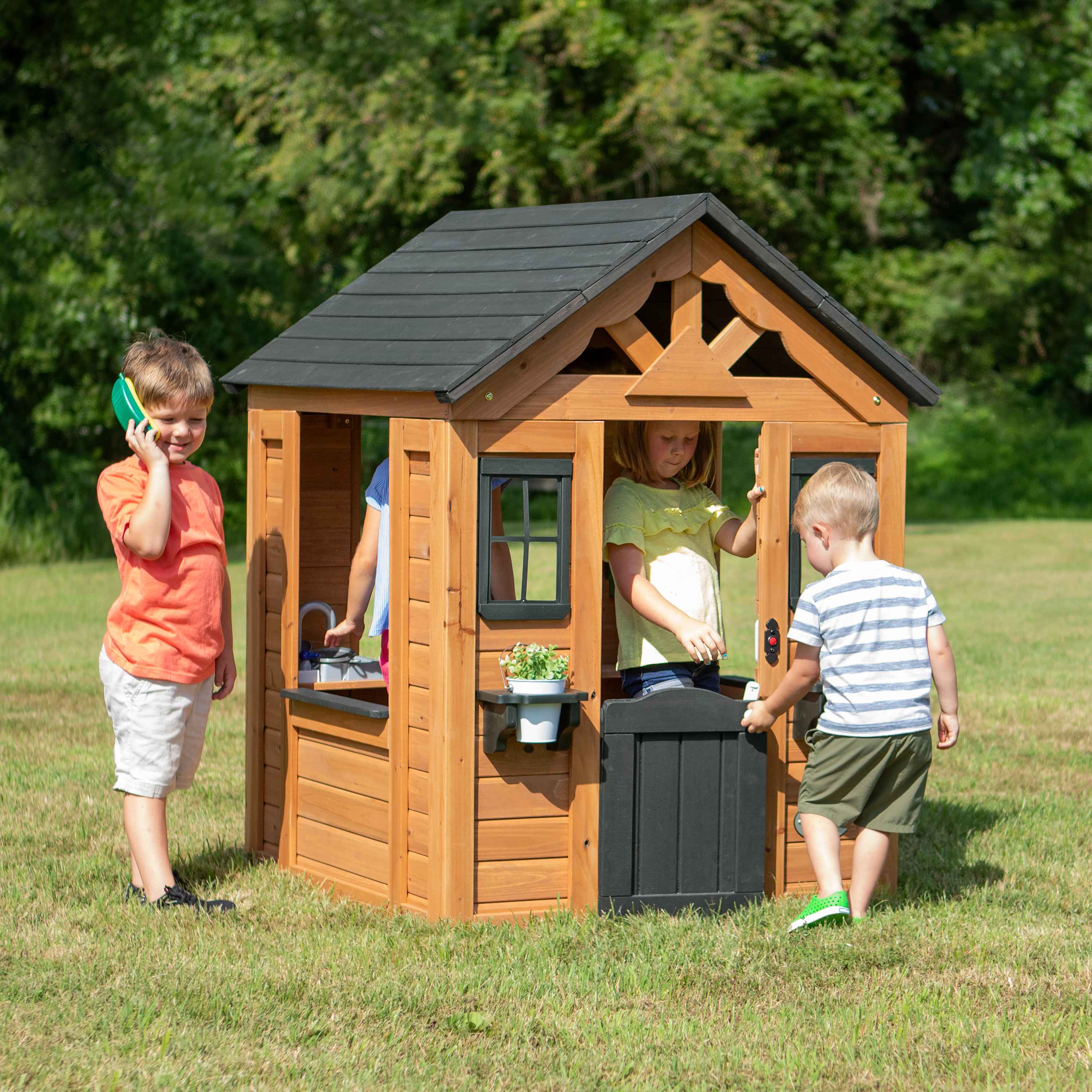 Sponsored - Banner X Advertisement for Backyard Discovery's Wooden Playhouses with a product image and shop now button.