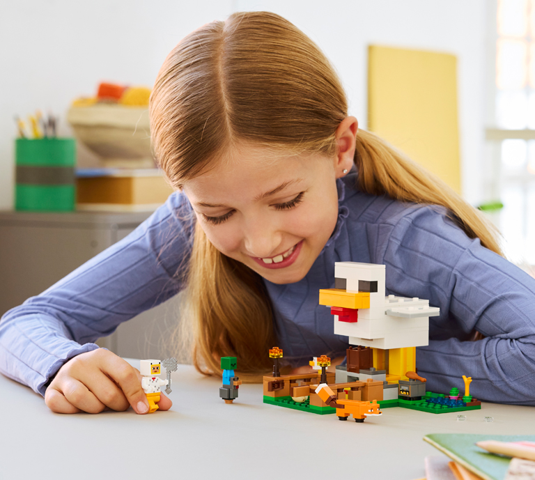 Girl playing with LEGO Minecraft set