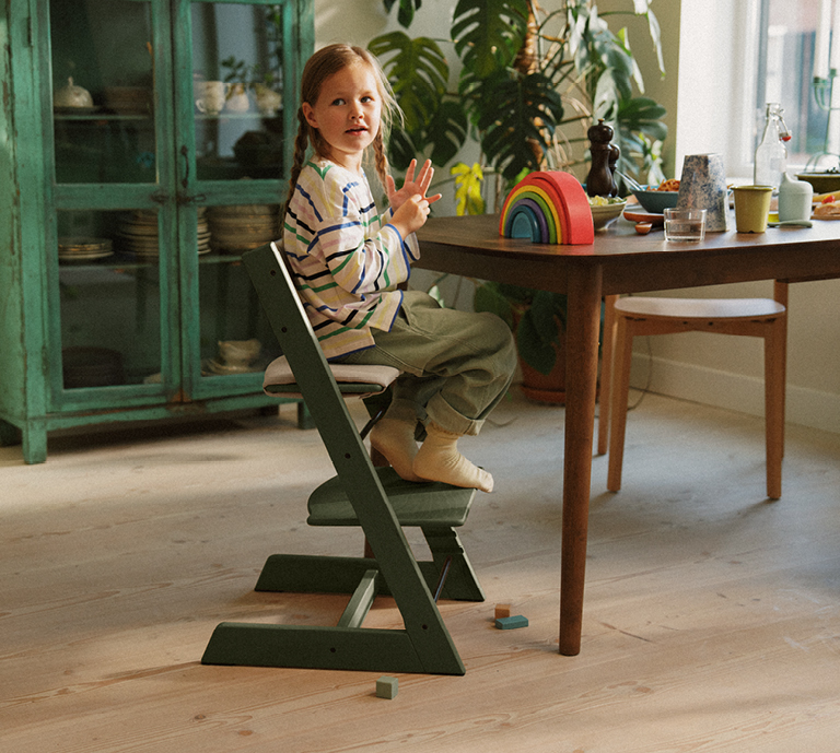 Picture of child on marble green Tripp Trapp in home setting 