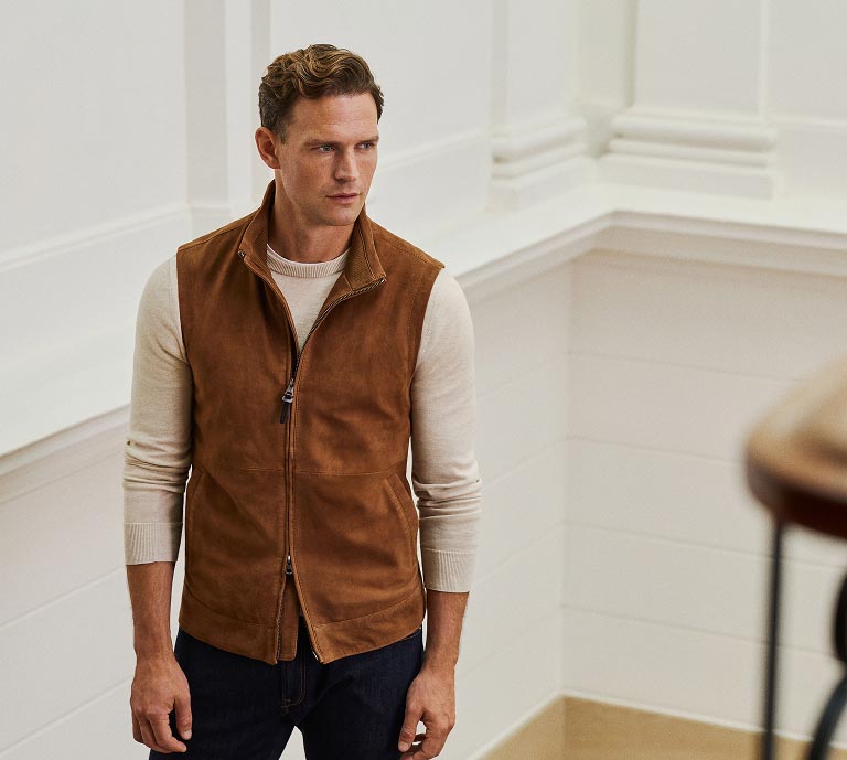 Image of man wearing Hackett new season menswear; a brown suede waistcoat