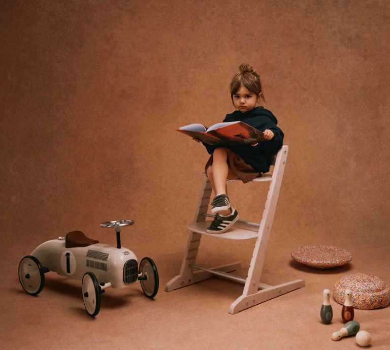 Banner advertisement for cybex highchairs, featuring an image of a little girl on a highchair with a book. Shop now button takes you to product listings for LEMO, IRIS and Click & Fold Highchairs