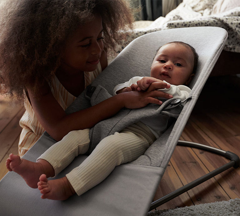 Showing a baby chilling in a BabyBjörn baby bouncer.