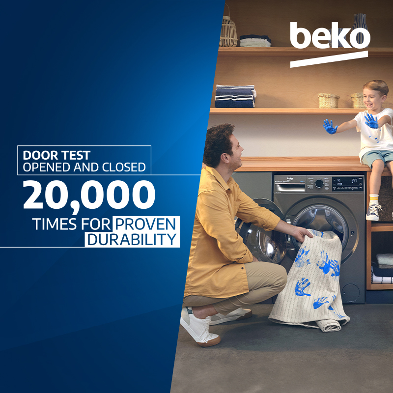 Sponsored Beko washing machine advertisement showing a father and child loading laundry into a washing machine, with text stating “Door test opened and closed 20,000 times for proven durability.