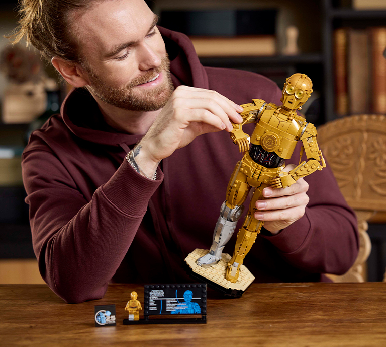 Banner Advertisement for LEGO Star Wars celebrating May the 4th sets with an image of a person building a product.
