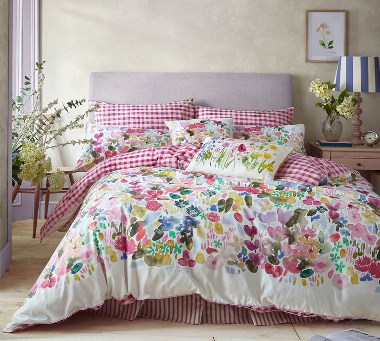 The Bluebellgray Flora Cerise bedding is a warm, uplifting design with loose, abstract painterly florals in a rich blend of lilacs, purples, olive greens, and their signature pop of pink.